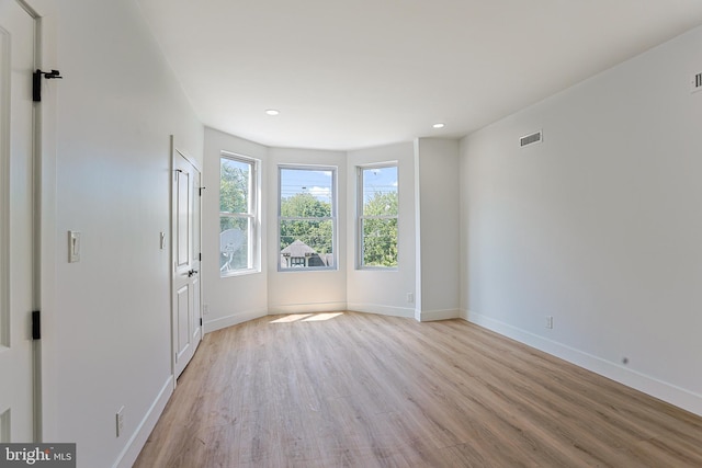 interior space featuring visible vents, recessed lighting, baseboards, and light wood-type flooring