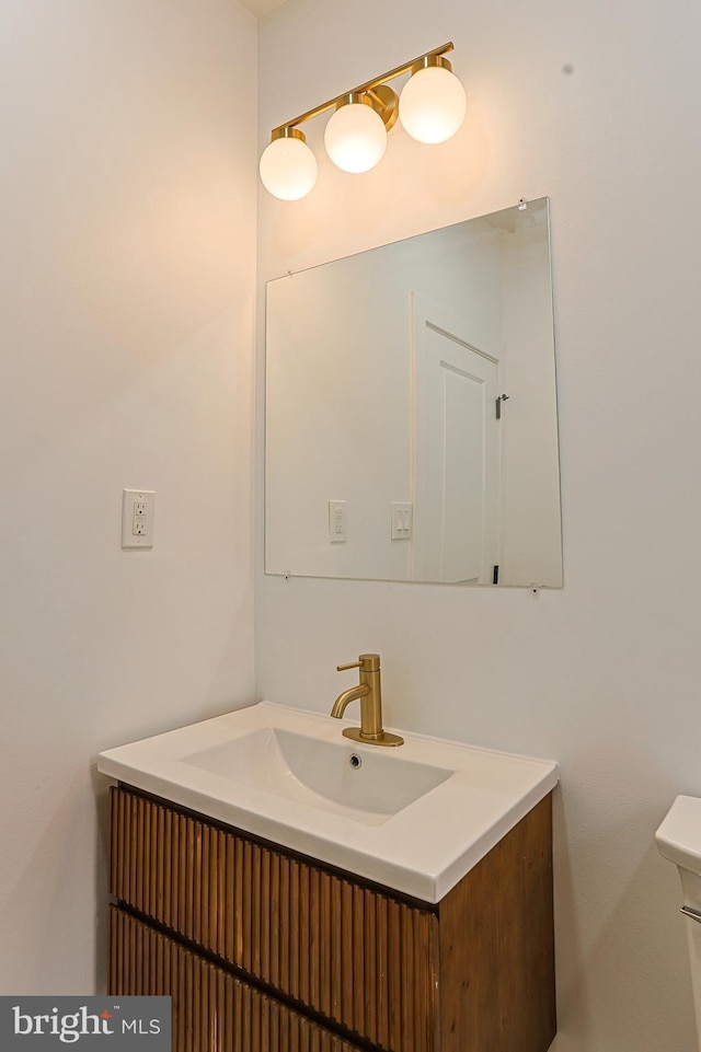 bathroom featuring vanity and toilet