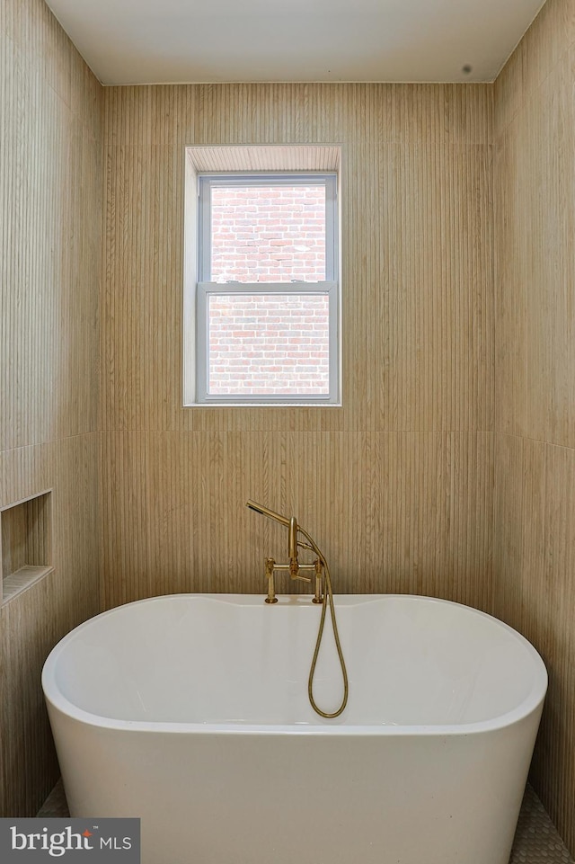 bathroom featuring a freestanding tub