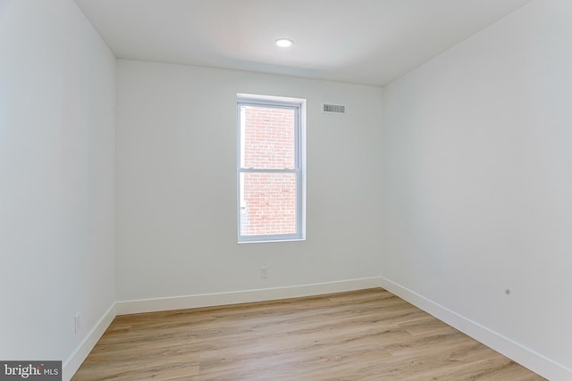 spare room featuring recessed lighting, baseboards, light wood finished floors, and visible vents