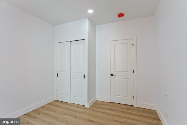 unfurnished bedroom with recessed lighting, baseboards, and light wood finished floors