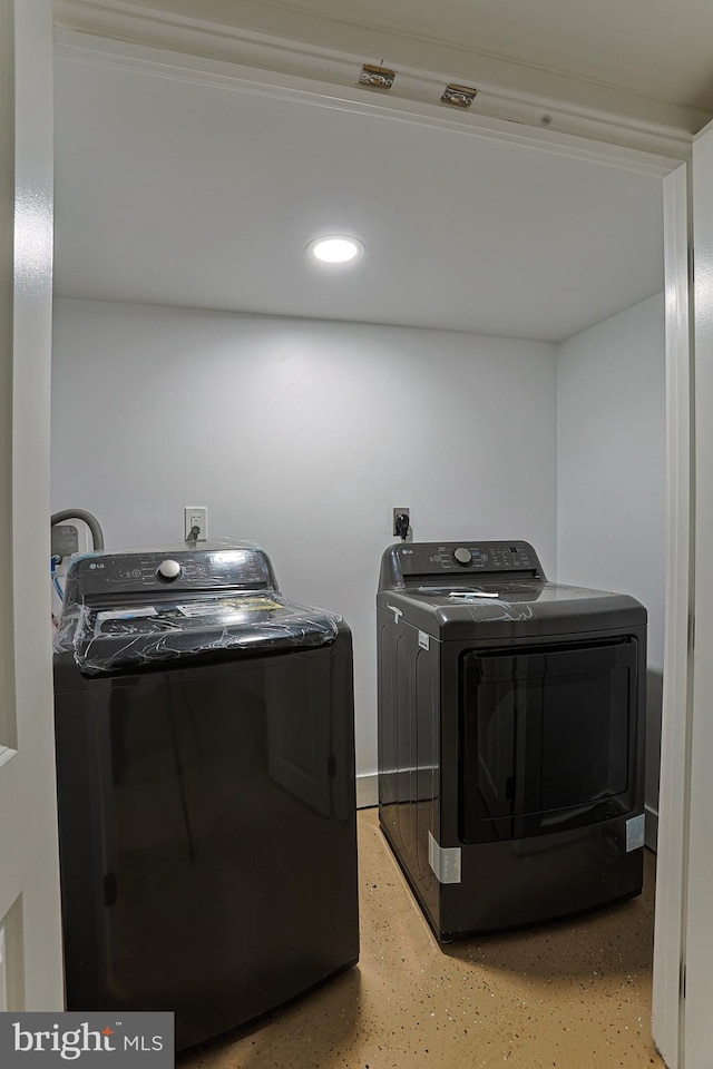 clothes washing area with laundry area and washing machine and clothes dryer