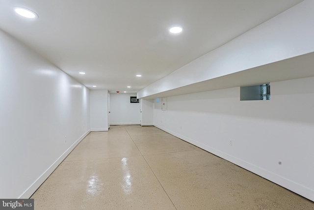 interior space with baseboards and recessed lighting