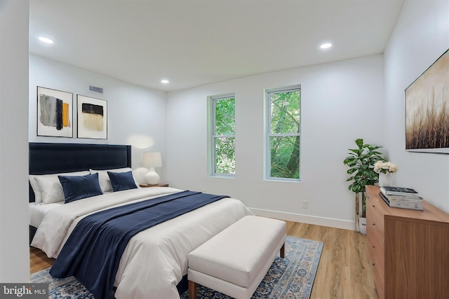 bedroom with recessed lighting, baseboards, visible vents, and light wood-style floors