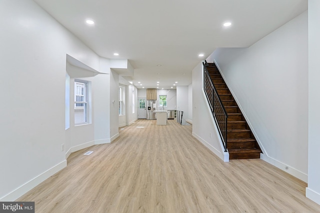 interior space with light wood-type flooring, recessed lighting, and baseboards