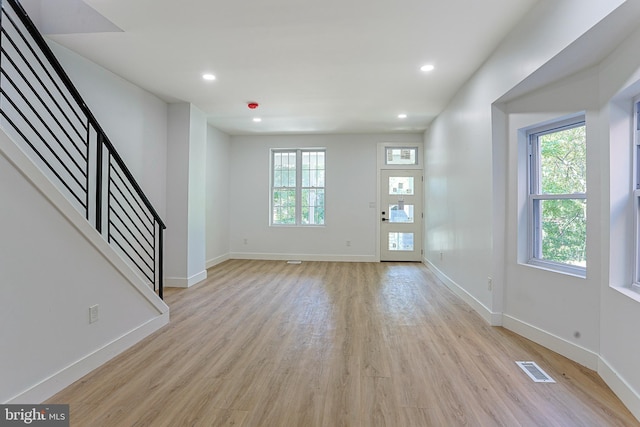 entryway with plenty of natural light and light wood finished floors
