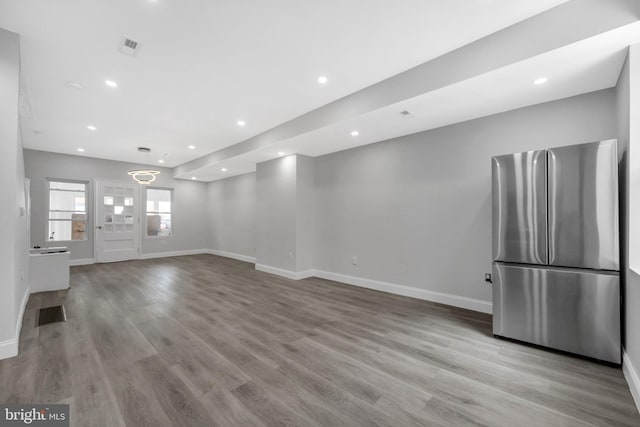 unfurnished living room featuring recessed lighting, baseboards, visible vents, and light wood-type flooring