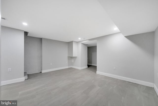 finished below grade area featuring recessed lighting, baseboards, and visible vents