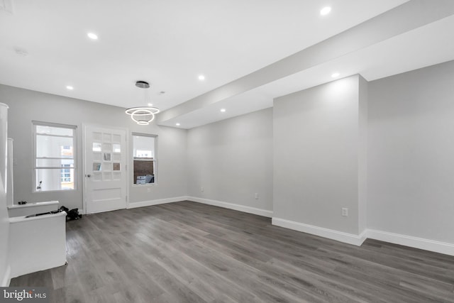 unfurnished living room featuring baseboards, recessed lighting, and wood finished floors