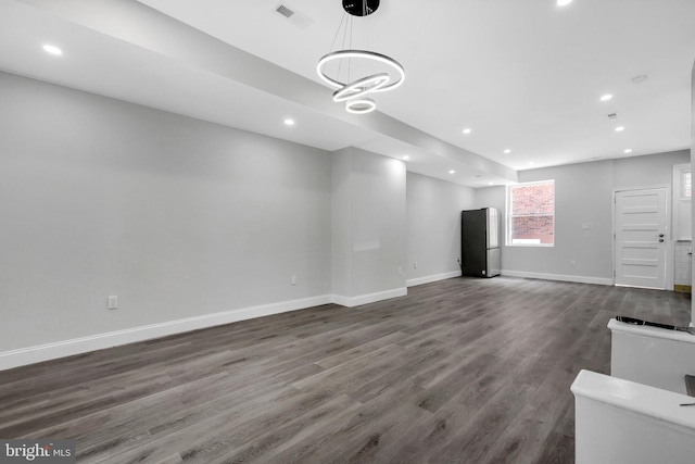 unfurnished living room featuring dark wood-style flooring, recessed lighting, baseboards, and visible vents