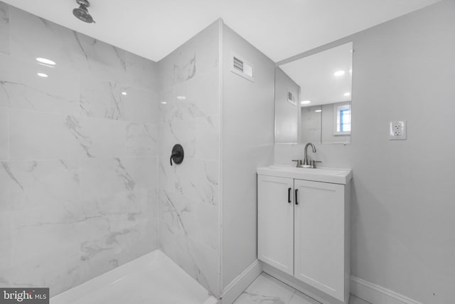 full bath with visible vents, baseboards, vanity, marble finish floor, and a marble finish shower