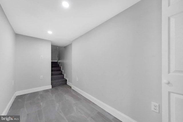 finished below grade area featuring recessed lighting, baseboards, and stairs