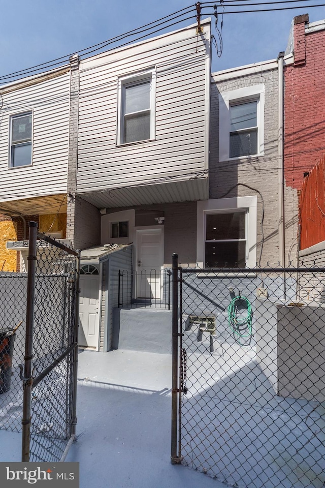 view of front of home with fence and a gate