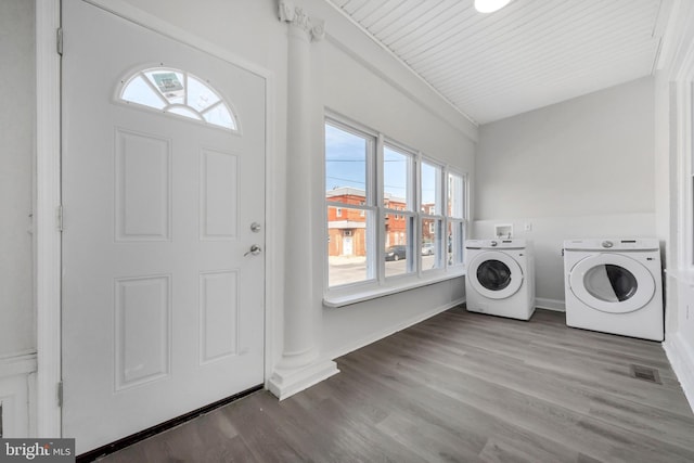 washroom featuring laundry area, visible vents, wood finished floors, baseboards, and separate washer and dryer