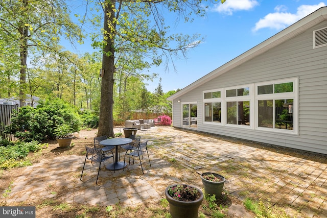 view of patio featuring outdoor lounge area, fence, and outdoor dining space
