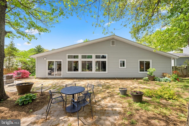 rear view of house featuring fence and a patio area