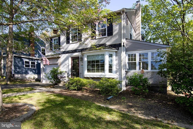 1108 W Mount Vernon Ave, Haddonfield, NJ 08033 - traditional home with an attached garage, stucco siding, a front yard, and a chimney