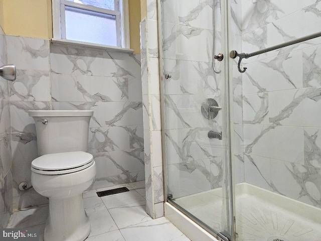 full bath featuring visible vents, tile walls, toilet, marble finish floor, and a marble finish shower