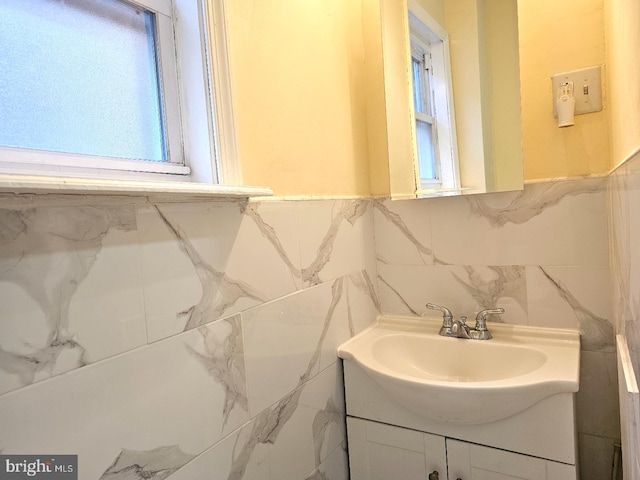 bathroom with tile walls and vanity