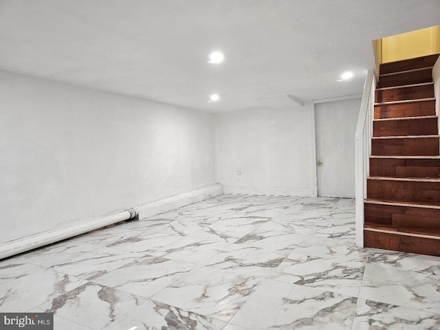 finished basement with baseboards, marble finish floor, recessed lighting, and stairs