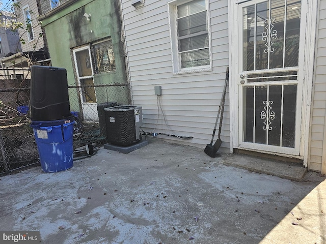 exterior space featuring fence and central AC