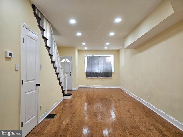 entrance foyer with recessed lighting, baseboards, visible vents, and wood finished floors