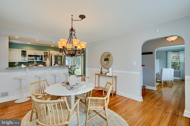 4255 Darleigh Rd, Baltimore, MD 21236 - dining area with arched walkways, light wood-type flooring, a chandelier, and recessed lighting