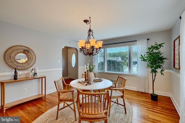 4255 Darleigh Rd, Baltimore, MD 21236 - dining area featuring arched walkways, wood finished floors, a chandelier, and baseboards