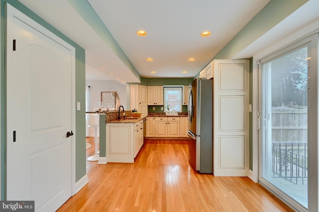 4255 Darleigh Rd, Baltimore, MD 21236 - kitchen featuring freestanding refrigerator, light wood-style floors, dark stone countertops, a peninsula, and recessed lighting