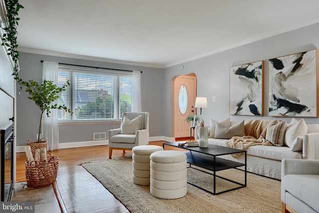 4255 Darleigh Rd, Baltimore, MD 21236 - living room featuring crown molding, wood finished floors, arched walkways, and baseboards