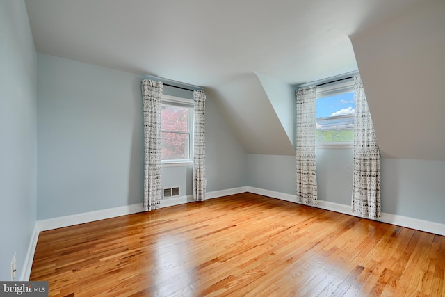 4255 Darleigh Rd, Baltimore, MD 21236 - additional living space featuring wood-type flooring, healthy amount of natural light, baseboards, and vaulted ceiling