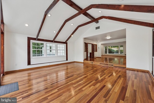 unfurnished living room with healthy amount of natural light, light wood finished floors, recessed lighting, and baseboards