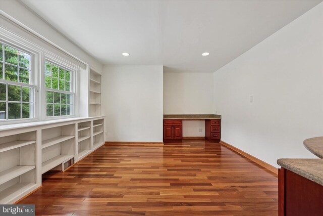 spare room featuring wood finished floors, recessed lighting, and baseboards