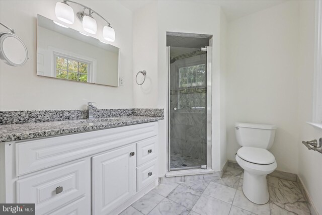bathroom with marble finish floors, a shower stall, toilet, and vanity