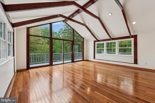 unfurnished living room featuring wood-type flooring, baseboards, and recessed lighting
