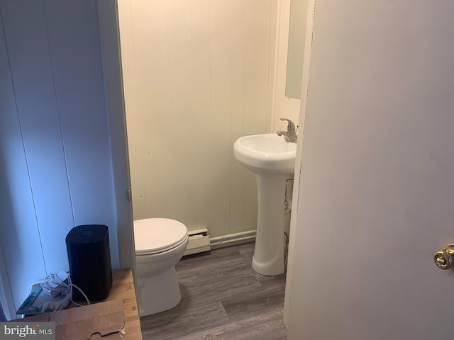 145 Grove St, Howard, PA 16841 - half bathroom featuring toilet, wood finished floors, and a baseboard radiator