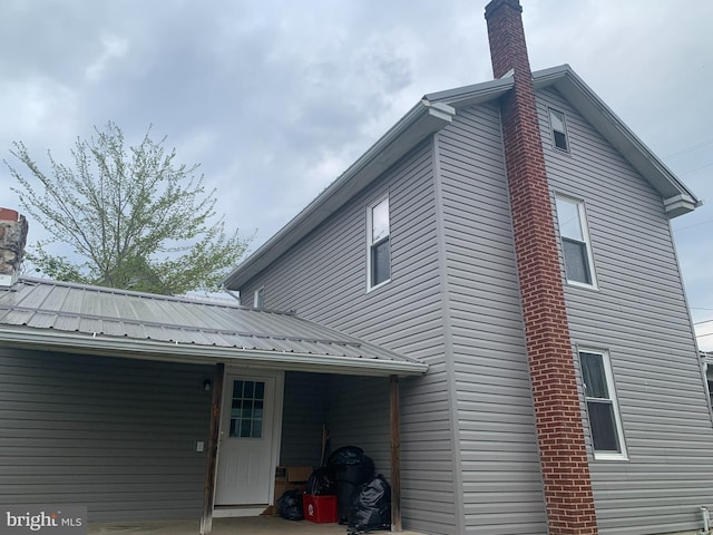 145 Grove St, Howard, PA 16841 - view of side of property featuring a chimney and metal roof