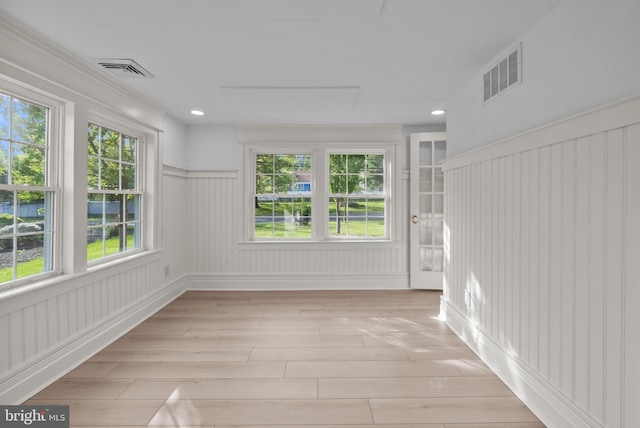 unfurnished sunroom with visible vents