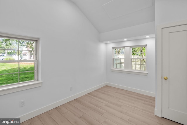 spare room featuring high vaulted ceiling, plenty of natural light, and wood finished floors