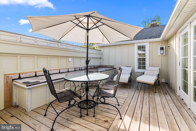 wooden terrace featuring outdoor dining space