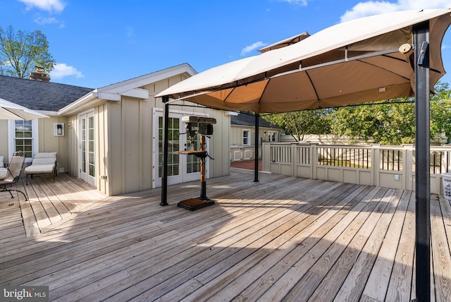 wooden deck featuring french doors and a gazebo