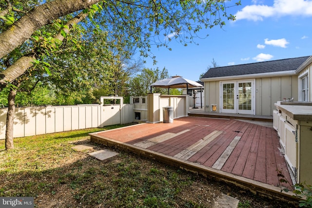 deck with french doors, fence, and a gazebo