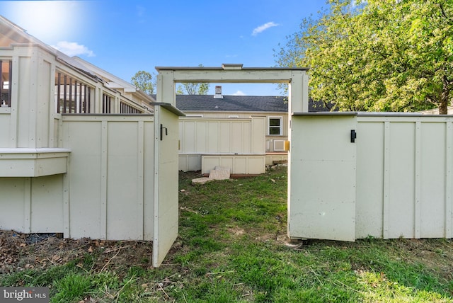 view of yard featuring an outdoor structure, fence, and a shed