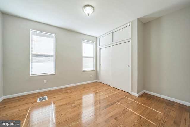 2426 S Chadwick St, Philadelphia, PA 19145 - unfurnished bedroom with light wood-style floors, visible vents, baseboards, and a closet