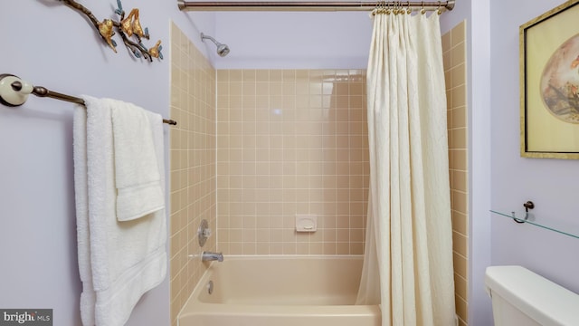 full bath with shower / bath combo with shower curtain and toilet