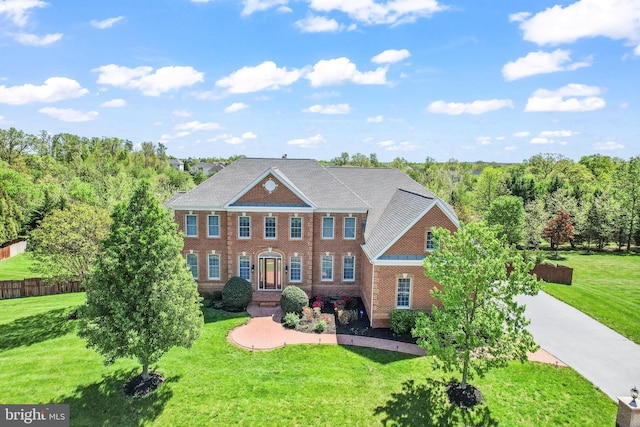 view of front of property with brick siding and a front yard