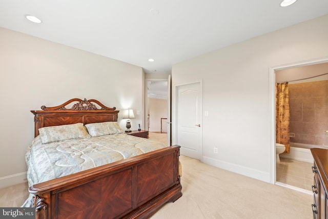 bedroom featuring connected bathroom, recessed lighting, baseboards, and light carpet