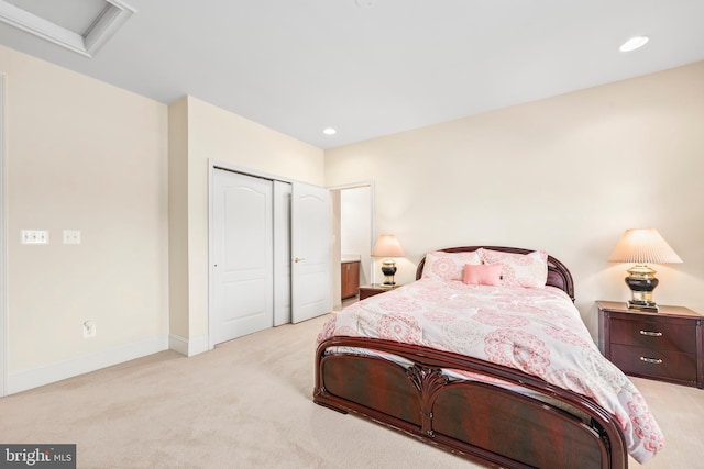 bedroom with a closet, light carpet, baseboards, attic access, and recessed lighting