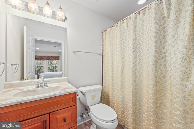 full bath featuring vanity and toilet