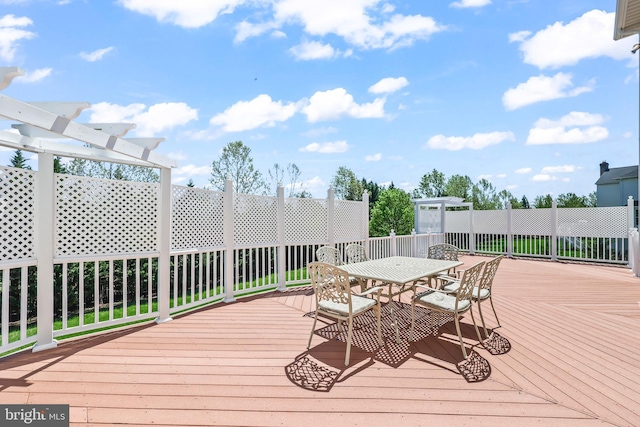 wooden terrace featuring outdoor dining area and a pergola